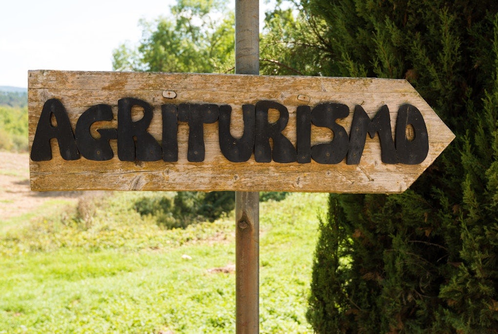 Handmade wooden agriturismo sign in Tuscany – agritourism is a typical concept of bed and breakfast in a farming environment in Italy.
